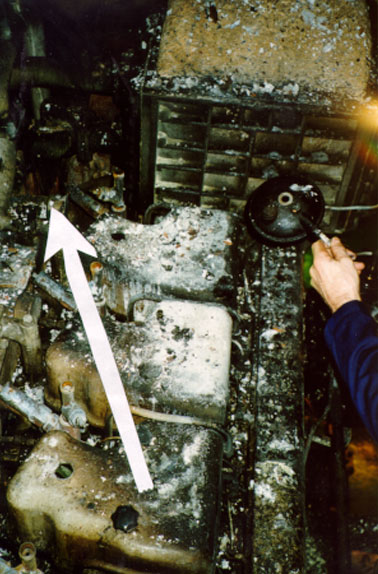 Horizontal charring pattern pointing towards the seat of the fire at the exposed exhaust piping