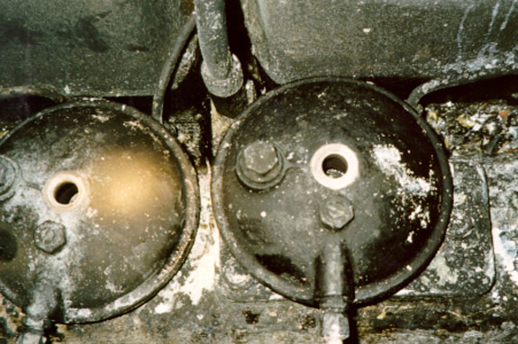 Cover from forward fuel filter (right) modified by removal of the gasket mounting groove
